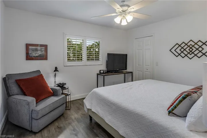 Bedroom featuring wood finished floors, a ceiling fan, and a closet