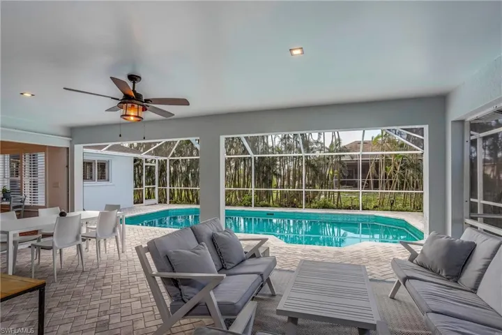 Outdoor pool with outdoor lounge area, a patio area, and a lanai