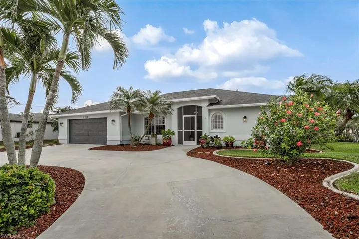 Ranch-style house with stucco siding, an attached garage, driveway, and a shingled roof