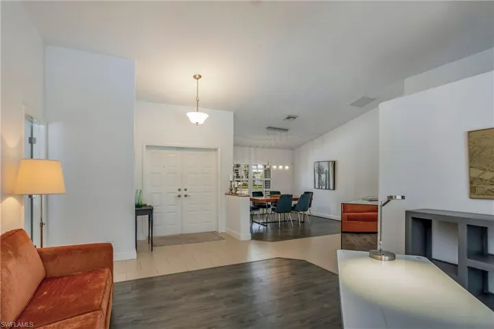 Tiled living area featuring baseboards