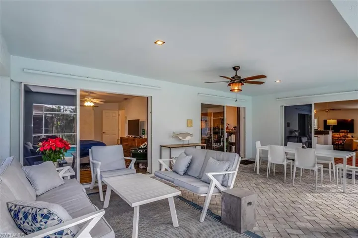 View of patio with ceiling fan, an outdoor living space, and outdoor dining area