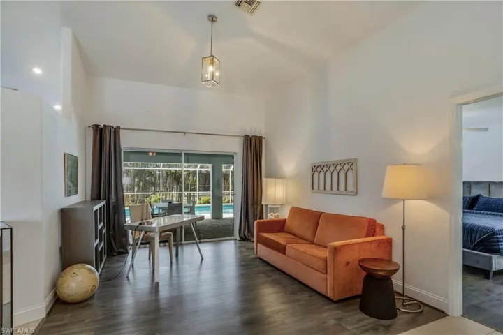 Living room with wood finished floors and a high ceiling