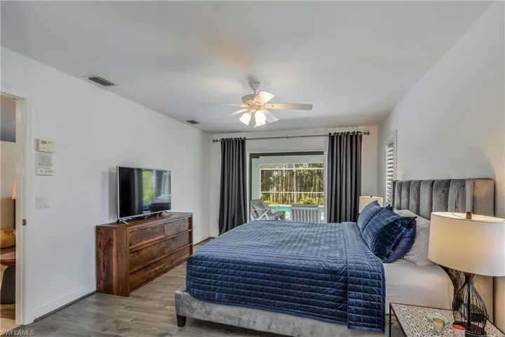 Bedroom with wood finished floors and ceiling fan