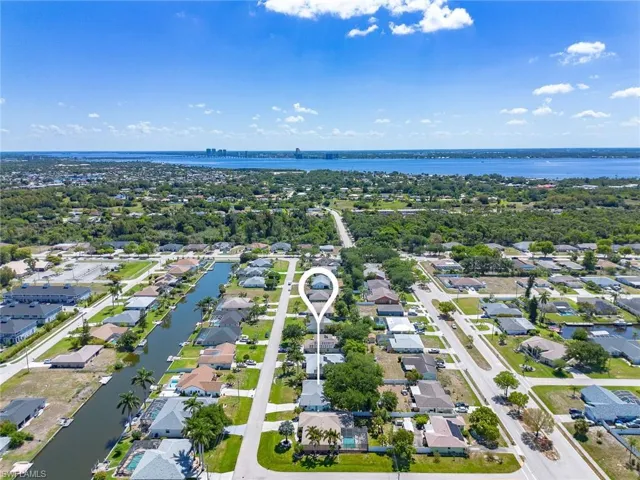 Aerial perspective showcasing a residential neighborhood with canal access