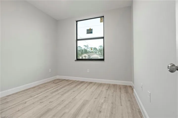 Empty room featuring light wood-style floors and baseboards