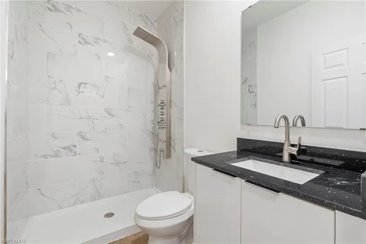 Full bath with vanity and a stall shower