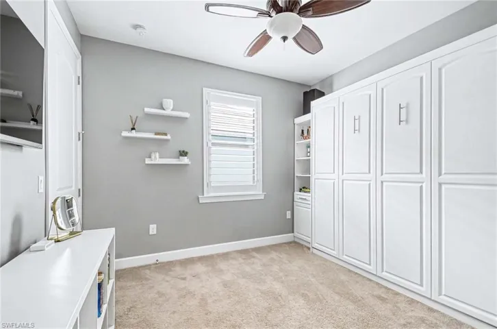 Unfurnished office featuring light colored carpet and ceiling fan