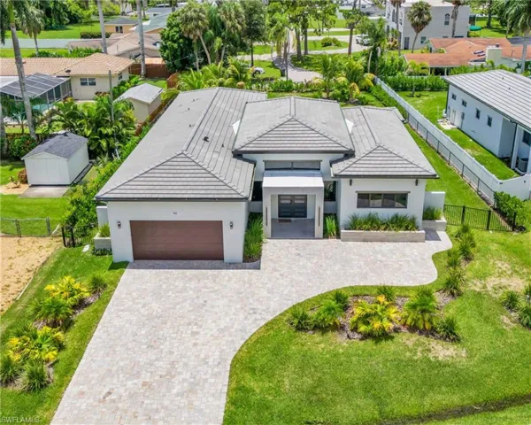 View of front of home with a garage and a front yard