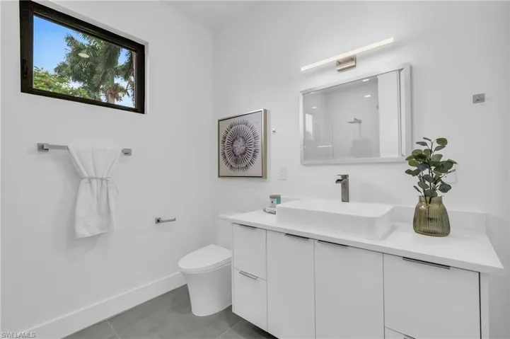 Bathroom with vanity, toilet, and tile patterned flooring