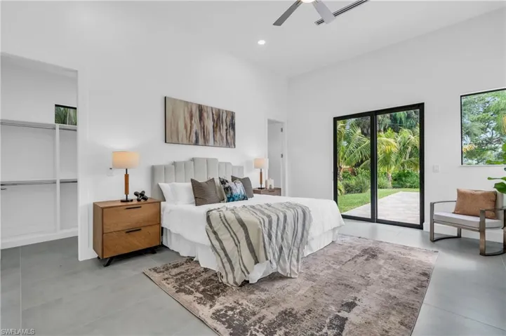 Bedroom with access to outside, ceiling fan, and tile patterned floors