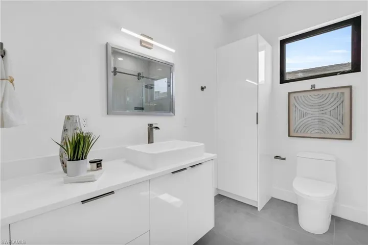 Bathroom featuring tile patterned floors, vanity, and toilet