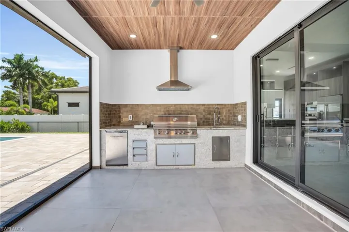 View of patio / terrace with sink, a grill, exterior kitchen, and a fenced in pool