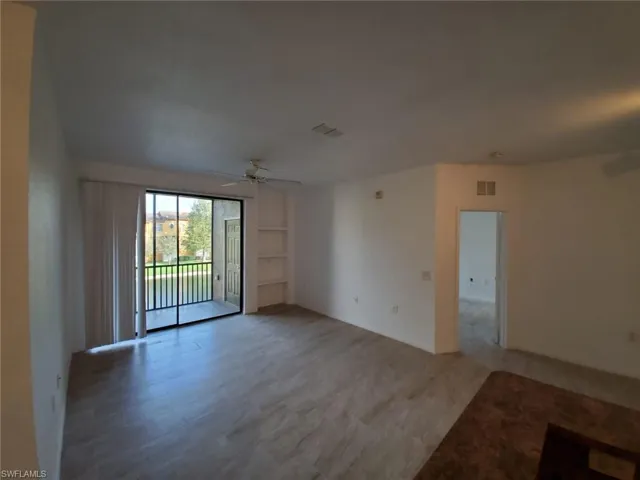 Spare room with ceiling fan and light wood-style flooring