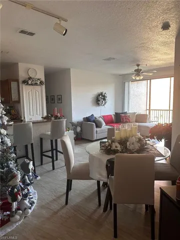 Dining space with a ceiling fan and a textured ceiling