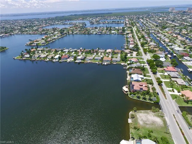 Aerial overview of property's location with a nearby body of water and nearby suburban area
