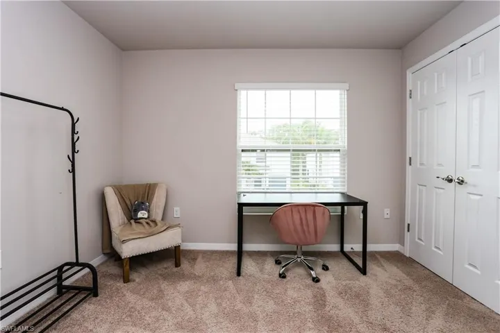 Home office featuring light colored carpet