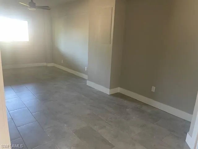 Spare room featuring baseboards and a ceiling fan