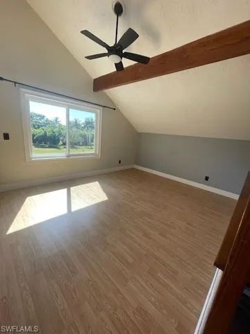 Additional living space featuring a textured ceiling, light wood-style flooring, and a ceiling fan