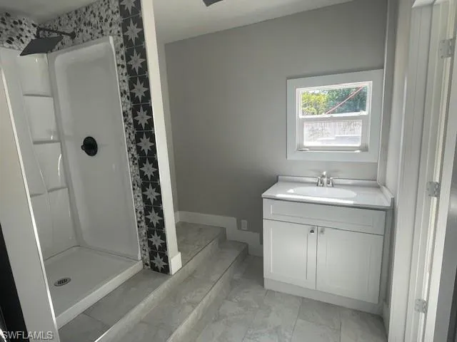 Bathroom with vanity and a stall shower