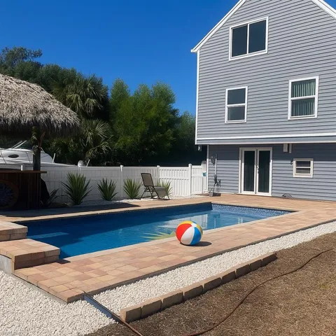 View of pool with french doors, a patio, and a fenced backyard
