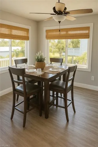 Dining area featuring light wood finished floors and a ceiling fan
