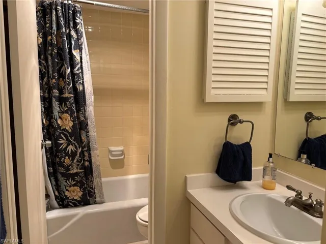 Full bathroom with vanity, toilet, and shower / tub combo
