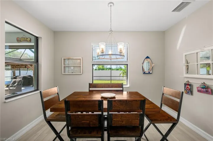 Dining space featuring a chandelier, healthy amount of natural light, and light wood-style floors