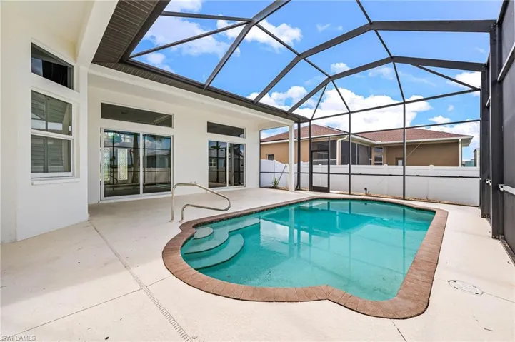 View of swimming pool featuring a lanai and a patio area