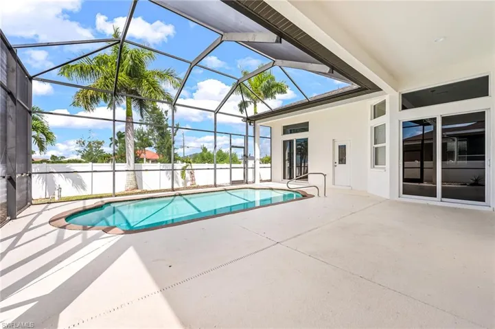 View of pool with a lanai and a patio