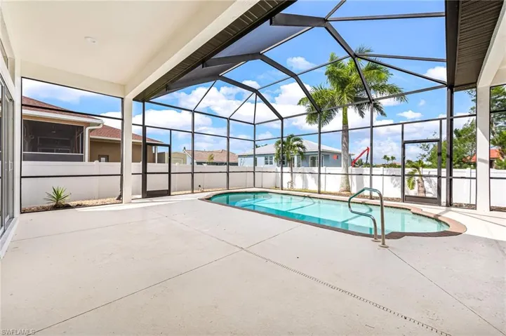 View of pool with a lanai and a patio area