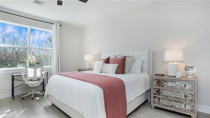 Bedroom with light hardwood / wood-style flooring and ceiling fan