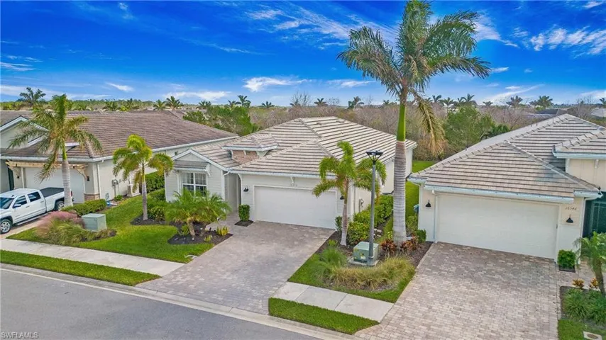 View of front of property with a garage and a front yard