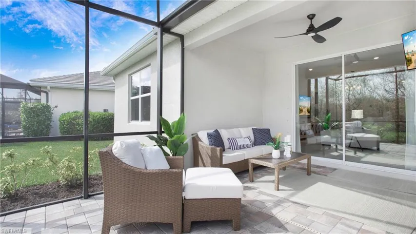 Sunroom with a wealth of natural light, beamed ceiling, and ceiling fan