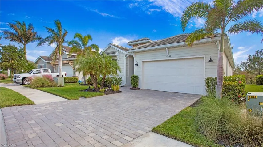 View of front of home with a front yard and a garage