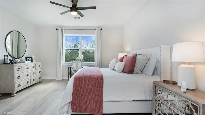 Bedroom featuring light hardwood / wood-style floors and ceiling fan