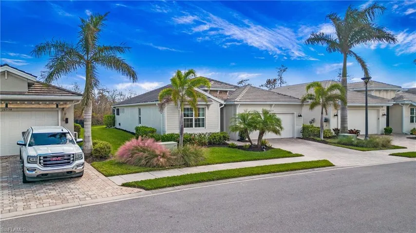 Ranch-style home with a front yard and a garage