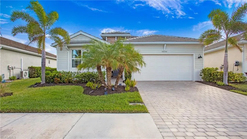 View of front facade, a front yard, and a garage