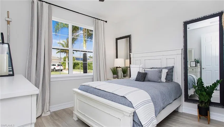 Bedroom#4 with multiple windows and light hardwood / wood-style floors