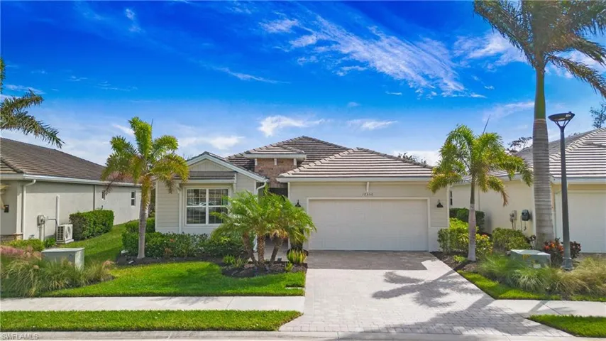 View of front of property featuring a front yard and a garage