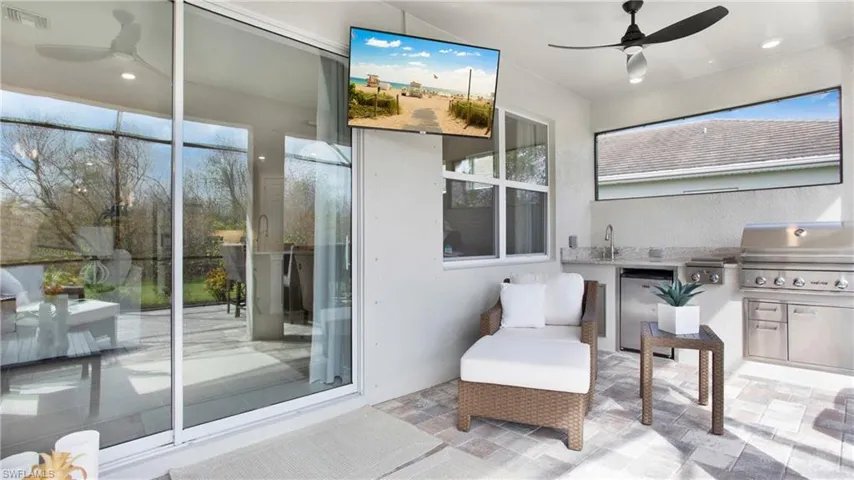 View of patio / terrace with grilling area, an outdoor kitchen, and ceiling fan