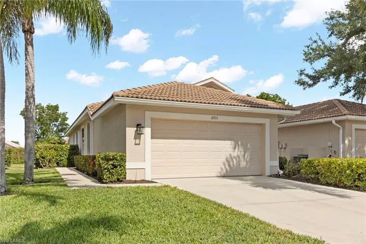 View of side of property with a garage and a yard