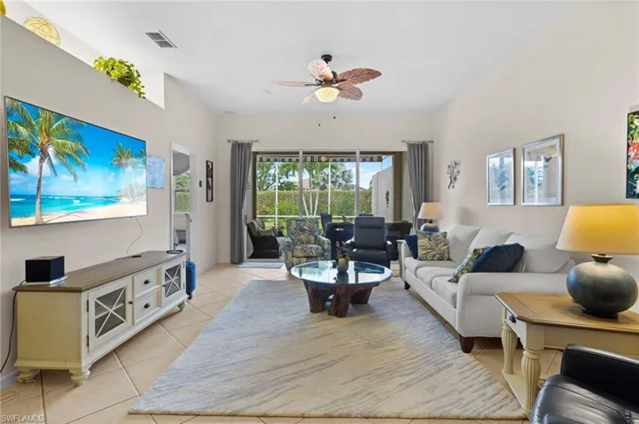 Tiled living room featuring ceiling fan