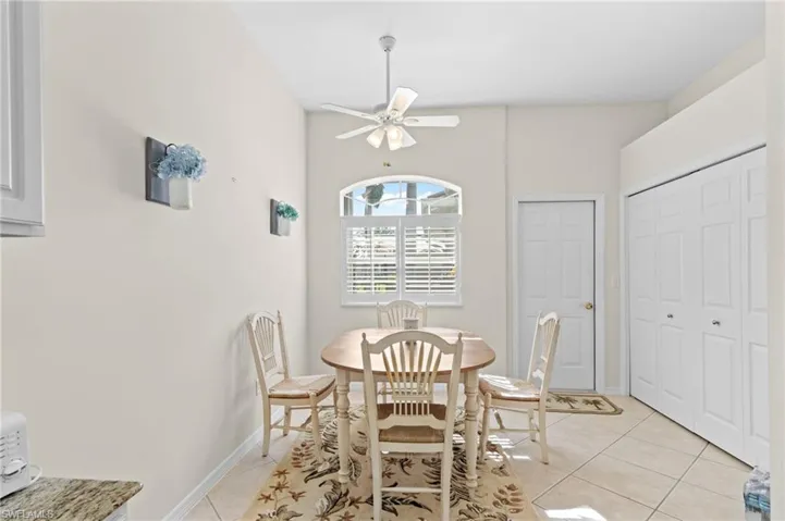 Tiled dining area featuring ceiling fan