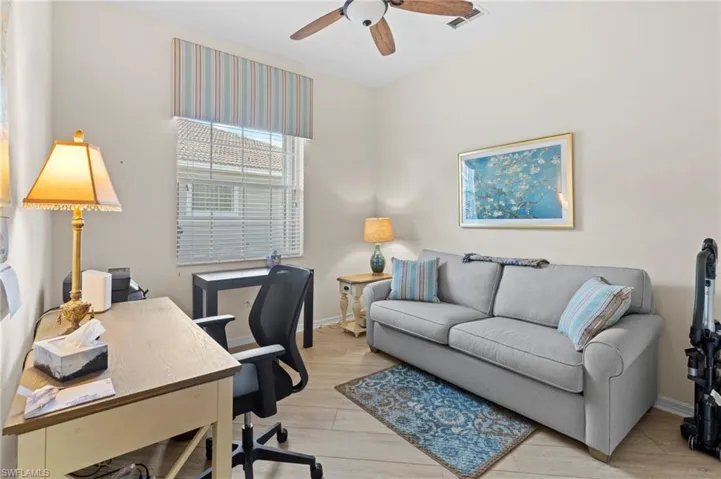 Office area with ceiling fan and light hardwood / wood-style floors
