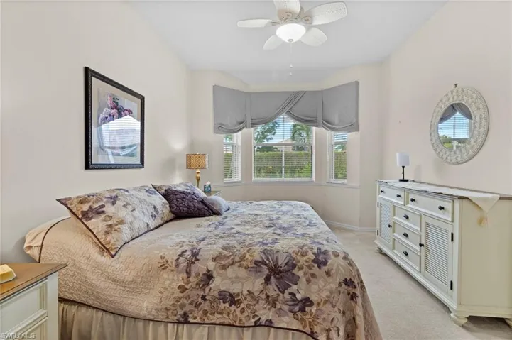 Bedroom featuring light colored carpet and ceiling fan