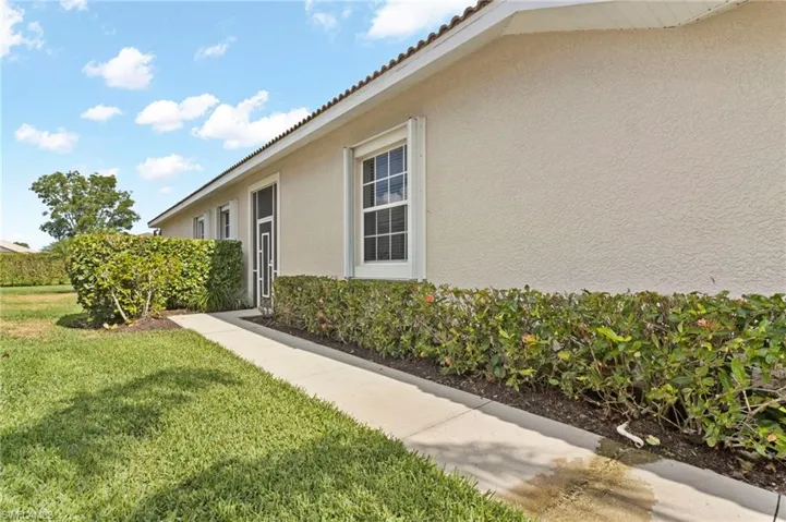 View of side of home featuring a yard
