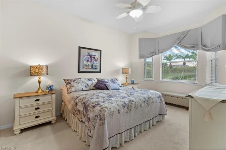 Bedroom featuring light colored carpet, a baseboard radiator, ceiling fan, and radiator