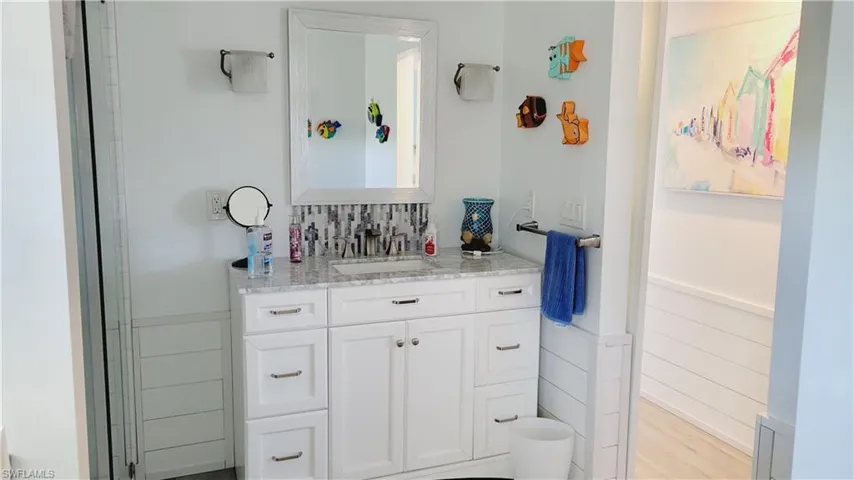 2nd Full bath featuring vanity, vinyl finished floors, and wainscoting