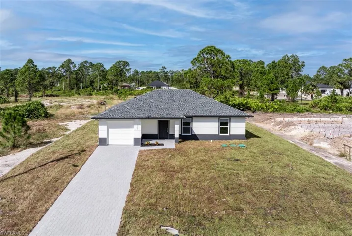 Ranch-style home with a garage and a front yard