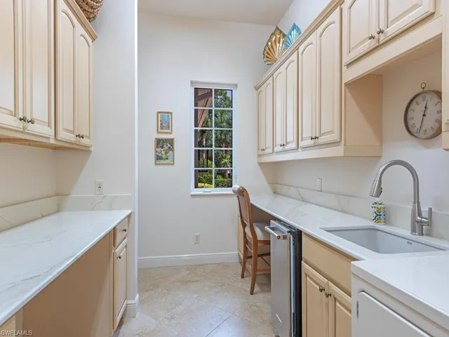 Recessed sink with a gooseneck faucet in Laundry room